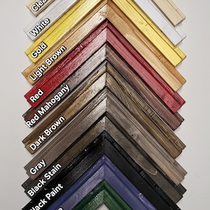 May include: A selection of double pane picture frames in various colors and finishes, including clear, white, gold, light brown, red, red mahogany, dark brown, gray, black stain, black paint, cottage blue, and green. The frames are arranged in a diagonal pattern, with the gloss finish on the left and the matte finish on the right.
