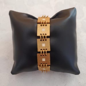 Vintage gold metal bracelet signed Biche De Bere from the 80s