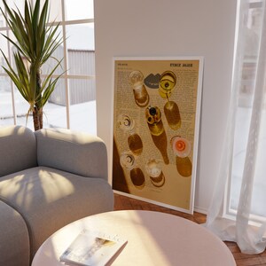 May include: A vintage-style print of glasses of wine on a newspaper background. The print has the text "Ryder Again" at the top. The print is framed and hanging on a white wall.