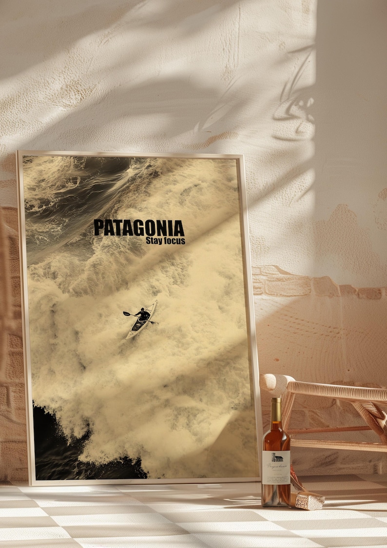 A paddler navigating rough ocean waves in a retro sepia tone. The phrase Patagonia Stay Focus highlights concentration and adventure. Perfect for water sports lovers and those seeking wilderness-inspired decor.