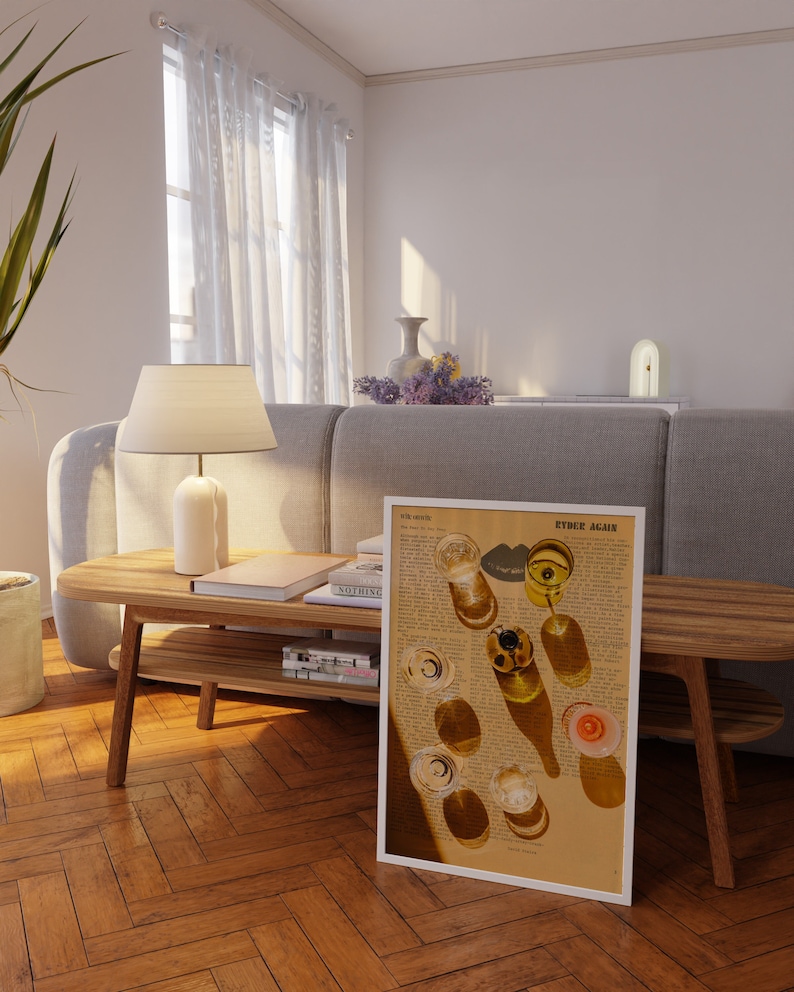 May include: A framed print of a vintage magazine page with a photograph of glasses of wine and their shadows. The text on the page reads "ETHEL AGNE".