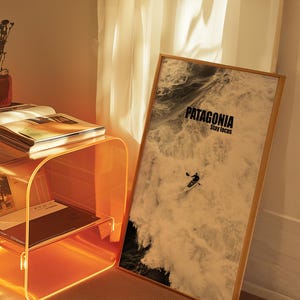 A paddler navigating rough ocean waves in a retro sepia tone. The phrase Patagonia Stay Focus highlights concentration and adventure. Perfect for water sports lovers and those seeking wilderness-inspired decor.
