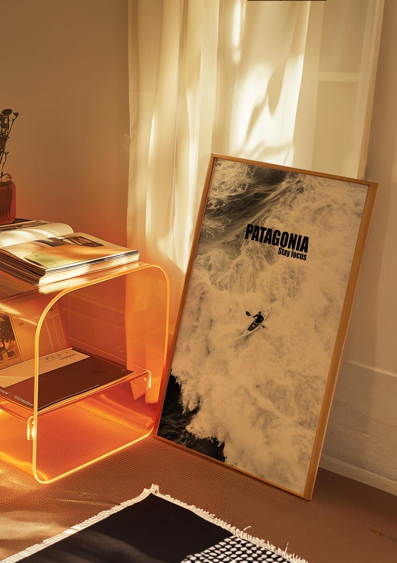 A paddler navigating rough ocean waves in a retro sepia tone. The phrase Patagonia Stay Focus highlights concentration and adventure. Perfect for water sports lovers and those seeking wilderness-inspired decor.