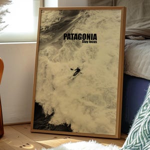 A paddler navigating rough ocean waves in a retro sepia tone. The phrase Patagonia Stay Focus highlights concentration and adventure. Perfect for water sports lovers and those seeking wilderness-inspired decor.