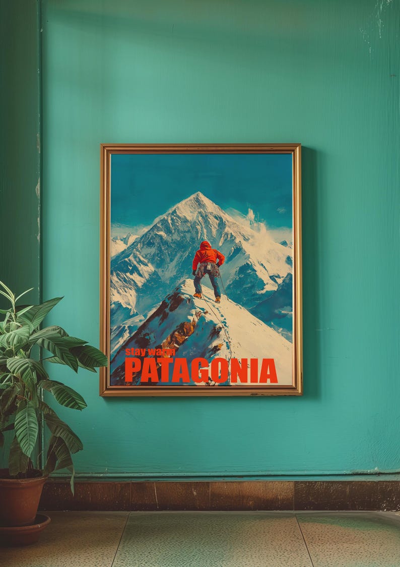 A striking poster featuring a climber in bright orange gear standing on a snowy mountain peak in Patagonia. This adventurous design captures the spirit of exploration and the beauty of the outdoors, perfect for nature lovers and thrill seekers.