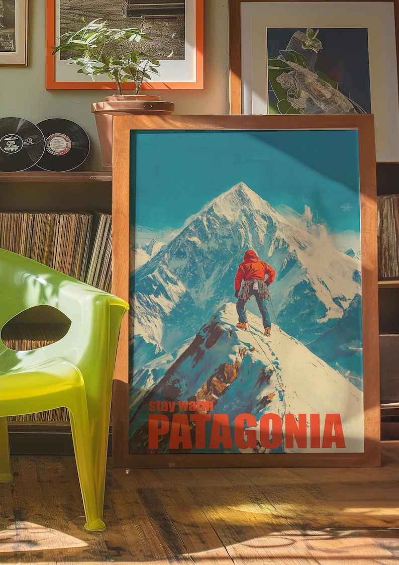 A striking poster featuring a climber in bright orange gear standing on a snowy mountain peak in Patagonia. This adventurous design captures the spirit of exploration and the beauty of the outdoors, perfect for nature lovers and thrill seekers.