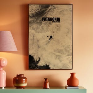 A paddler navigating rough ocean waves in a retro sepia tone. The phrase Patagonia Stay Focus highlights concentration and adventure. Perfect for water sports lovers and those seeking wilderness-inspired decor.
