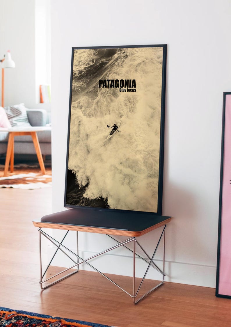 A paddler navigating rough ocean waves in a retro sepia tone. The phrase Patagonia Stay Focus highlights concentration and adventure. Perfect for water sports lovers and those seeking wilderness-inspired decor.