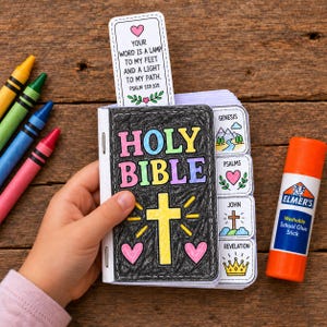 May include: A DIY paper Holy Bible craft project featuring a black cover with colorful text, a yellow cross, and pink hearts. It includes tabbed pages labeled Genesis, Psalms, John, and Revelation, plus a bookmark with Psalm 119:105 text.