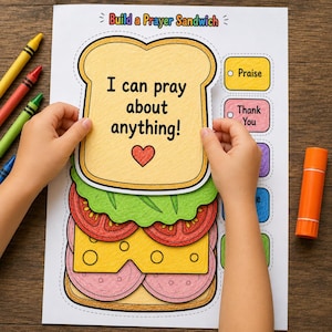 May include: A paper activity sheet titled Build a Prayer Sandwich featuring a large bread slice cutout with the text I can pray about anything! and a red heart. Below are illustrations of lettuce, tomato, cheese, and meat slices to assemble.