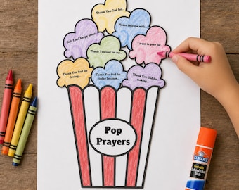 Op de afbeelding: Een papieren knutselwerk getiteld Pop Prayers met een rood-wit gestreepte popcornemmer en kleurrijke, wolkvormige uitsparingen. Elke wolk bevat tekstprompts zoals Thank You God for. Een roze kleurpotlood kleurt een van de wolken in.