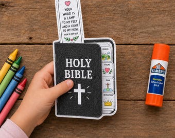 May include: A paper craft Holy Bible booklet with a black cover, a white cross, and a pull-out bookmark featuring the text Psalm 119:105. The booklet includes tabs for Genesis, Psalms, John, and Revelation, accompanied by crayons and a glue stick.