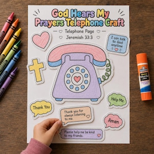 May include: A children's craft project titled "God Hears My Prayers Telephone Craft." The image features a large, outlined telephone, a cross, a heart, and speech bubbles with phrases like "Thank You" and "Help Me." Crayola crayons and a glue stick are also visible.