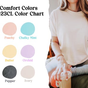 K&ouml;nnte beinhalten: Farbkarte mit sechs Farbmustern, die mit "Peachy", "Chalky Mint", "Butter", "Orchid", "Pepper" und "Ivory" beschriftet sind. Die Karte ist mit "Comfort Colors 3023CL Color Chart" betitelt.