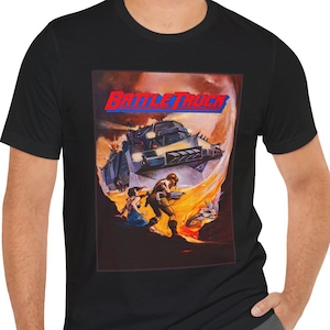 May include: A black t-shirt with a graphic of the movie poster for "Battletruck". The poster features a futuristic armored vehicle driving through a fiery landscape.