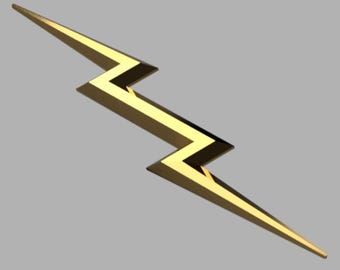 May include: A metallic gold lightning bolt emblem featuring a sharp, angular zigzag design. The object has a polished, reflective surface with defined edges and pointed ends, creating a distinct geometric shape oriented diagonally across the frame.