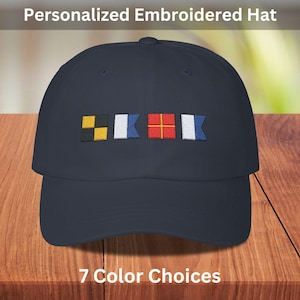 May include: A navy blue baseball cap with a white, blue, red, and yellow embroidered flag design. The text "7 Color Choices" is below the cap.