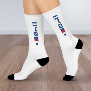 May include: White socks with black heels and a vertical row of nautical signal flags in blue, red, and white.