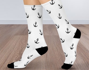 May include: White socks with a black anchor pattern. The socks are shown on a model's legs.