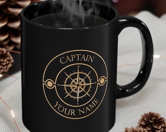 May include: Black ceramic coffee mug with a gold compass design and the text "CAPTAIN YOUR NAME".