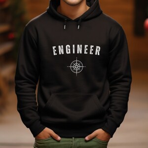 May include: Black hoodie with a white compass and the word "ENGINEER" printed on the front.