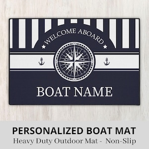 May include: A blue and white striped welcome mat with a compass and anchor design. The text "WELCOME ABOARD" and "BOAT NAME" is printed on the mat.