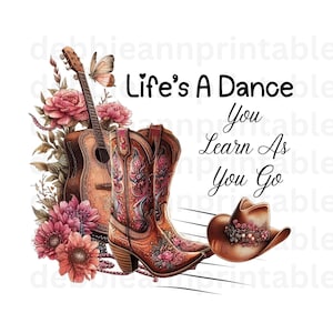 May include: A watercolour illustration of a guitar, cowboy boots, and a cowboy hat with floral accents. The text "Life's A Dance You Learn As You Go" is written in black lettering.