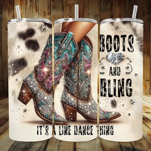 May include: A white tumbler with a cowhide pattern and a pair of sparkly cowboy boots. The text "Boots and Bling It's a Line Dance Thing" is printed on the tumbler.