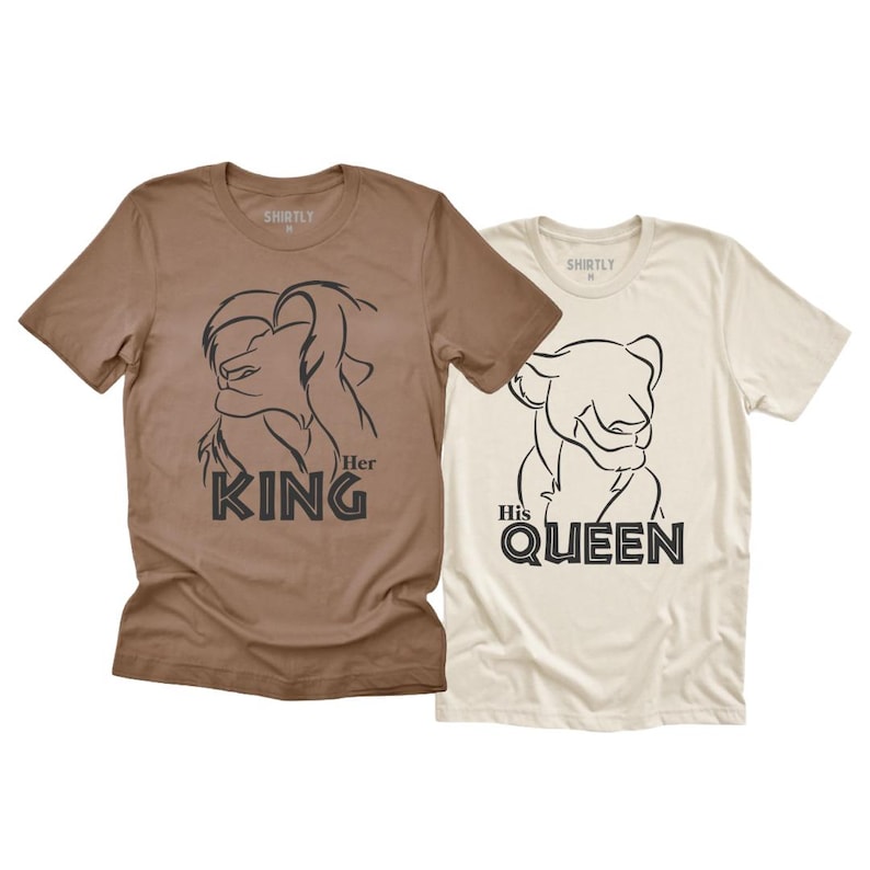 May include: Two short-sleeved t-shirts. One is brown with a lion graphic and the text "Her King". The other is off-white with a lioness graphic and the text "His Queen".
