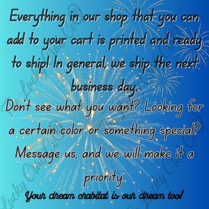 May include: A blue gradient background featuring gold firework illustrations and black text that reads: Everything in our shop that you can add to your cart is printed and ready to ship! Don't see what you want? Message us. Your dream crabitat is our dream too!