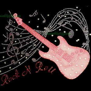 May include: Pink electric guitar with rhinestones and musical notes, surrounded by stars. The words "Rock N Roll" are written in pink rhinestones below the guitar.