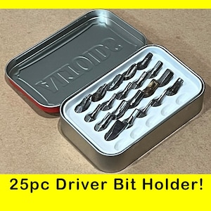 May include: A silver metal case with the word "VIVID" embossed on the lid. The case is open and contains 25 small silver screwdriver bits in a white plastic tray. 25pc Driver Bit Holder!