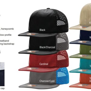 May include: A collection of Richardson 935 Rogue Wide Set Mesh caps in various colors including black, khaki, navy, olive, teal, and orange. These unstructured, six-panel, low-profile caps feature a performance fabric front and a honeycomb mesh back.
