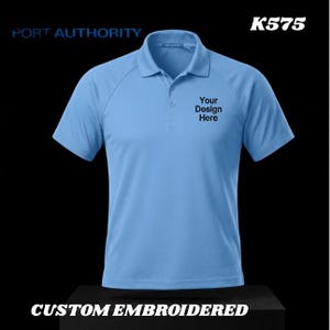 May include: Light blue polo shirt with short sleeves. The shirt has a collar and three buttons. The text "Your Design Here" is printed on the front. The text "PORT AUTHORITY" and "CUSTOM EMBROIDERED" are also visible.