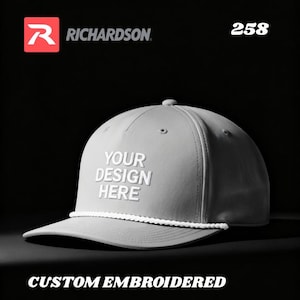 May include: Gray baseball cap with a white rope detail on the brim. The cap features the text "YOUR DESIGN HERE" in white, with the Richardson logo and the number "258" visible. The words "CUSTOM EMBROIDERED" are at the bottom.