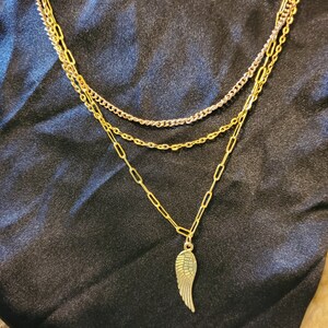 Drievoudige ketting met hoekvleugelbedel