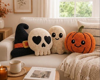 May include: A set of four decorative throw pillows featuring a black witch hat, a cream-colored skull with heart-shaped eyes, a cream-colored ghost with a smiling face, and an orange pumpkin with a green stem and a smiling face, all textured.