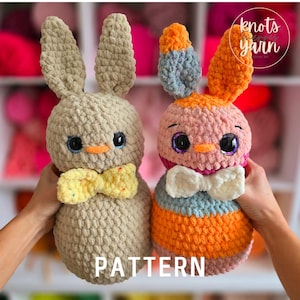 May include: Two crocheted stuffed animals, a bunny and a chick, both with big eyes and bows. The bunny is beige with a yellow bow, and the chick is pink with a white bow. The chick has orange, blue, and pink stripes. The image includes the text "knots & yarn".
