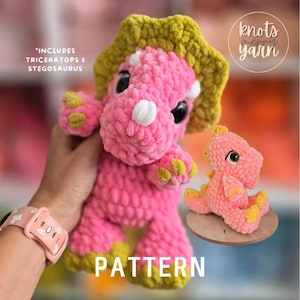 May include: A crochet triceratops plush toy in bright pink with a lime green frill and feet, alongside a smaller pink stegosaurus plush. Text on the image reads: INCLUDES TRICERATOPS & STEGOSAURUS, PATTERN, and the logo for knots merry yarn.