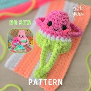 May include: A crocheted watermelon character with a smiling face, pink cheeks, and black eyes. The watermelon has a pink top, white middle, and green bottom with long green legs. The words "NO SEW" and "PATTERN" are visible.