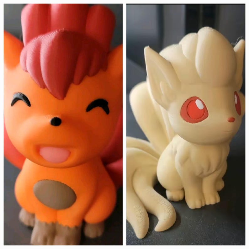 May include: Two 3D printed figurines of Pokemon characters. The first is a red and orange Vulpix with a brown spot on its belly. The second is a white and cream colored Ninetails with red eyes.
