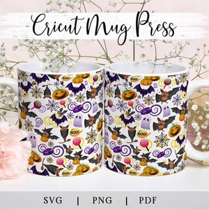 May include: Two white ceramic mugs with a Halloween themed design. The mugs feature bats, ghosts, pumpkins, candy, and spiderwebs. The text "BOO!" appears on the mugs.