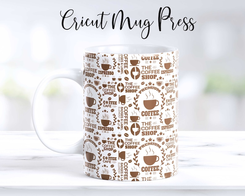 May include: White ceramic mug with a brown coffee shop design. The mug features a repeating pattern of coffee cups, coffee beans, and the text "The Coffee Shop".