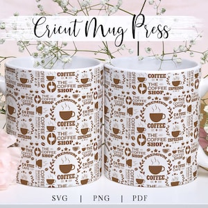 May include: Two white ceramic mugs with a brown and white coffee shop design. The mugs have a repeating pattern of coffee cups, coffee beans, and the text "The Coffee Shop".