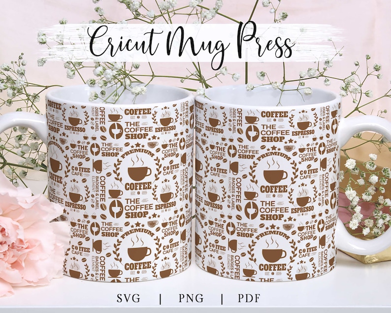 May include: Two white ceramic mugs with a brown and white coffee shop design. The mugs have a repeating pattern of coffee cups, coffee beans, and the text "The Coffee Shop".