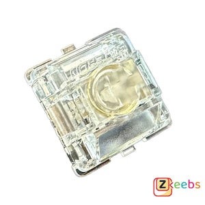 以下が含まれることがあります： 金色の接点プレートが付いた透明なプラスチック製のメカニカルキーボードスイッチ。スイッチはキーボードでの使用を目的としています。