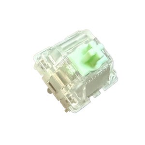 May include: A clear plastic mechanical keyboard switch with a light green stem.