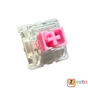 Könnte beinhalten: Ein transparenter mechanischer Tastaturschalter mit einem rosa Schaft und einem transparenten Gehäuse. Der Schalter hat ein taktiles Gefühl und ist für Gaming und Tippen konzipiert.