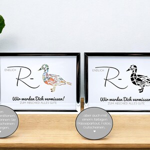 May include: Two silver-framed prints featuring a stylized duck graphic, the text "ENDLICH R-" and "Wir werden Dich vermissen! ZUM ABSCHIED ALLES GUTE". One duck is multicolored with geometric shapes, while the other is solid black with geometric lines.
