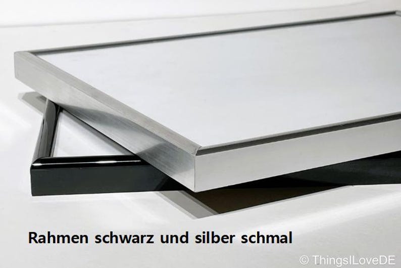 May include: A silver and black picture frame with a narrow border.